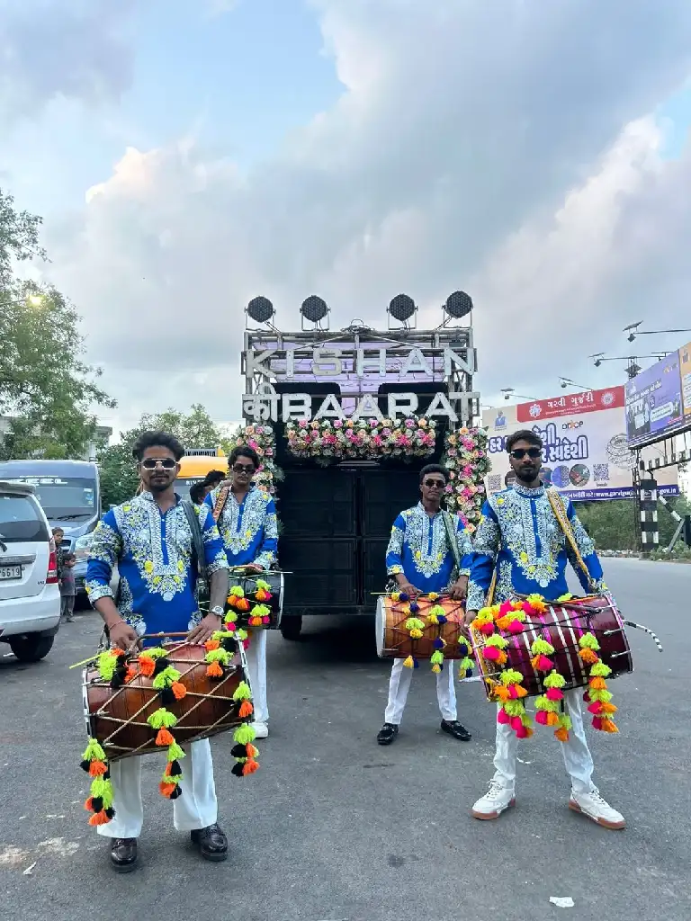 Dhol players energising a baraat procession at night